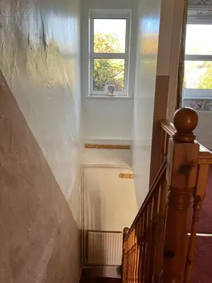 a stairway with a window and a stair case at Cosy cottage in Snowdonia hamlet in Frongoch