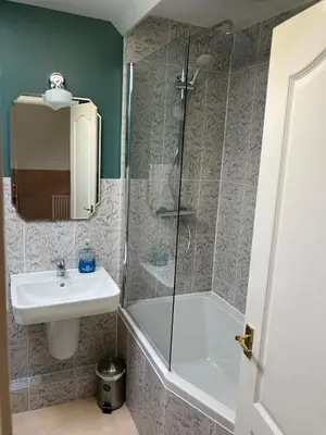 a bathroom with a shower and a sink and a tub at Cosy cottage in Snowdonia hamlet in Frongoch