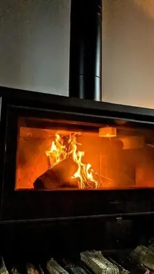 a fireplace with a fire in it at Tyn-Y-Berth Sleeps 27 luxury group accommodation in Tal-y-llyn