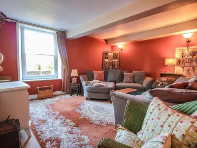 a living room with red walls and couches at 10 Upper Linney in Ludlow