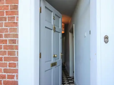 a hallway with blue doors and a brick wall at 10 Upper Linney in Ludlow