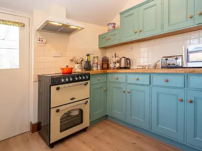 a kitchen with blue cabinets and an oven at Quintessentially English 3-Bed Home in Ludlow - Pass the Keys in Ludlow