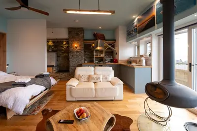 a living room with a white couch and a table at Bermo Cwtch in Barmouth