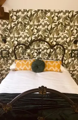 a bed with two pillows on it in a bedroom at North Cottage in Berriew