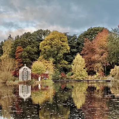 a garden with a gazebo in the middle of a lake at North Cottage in Berriew