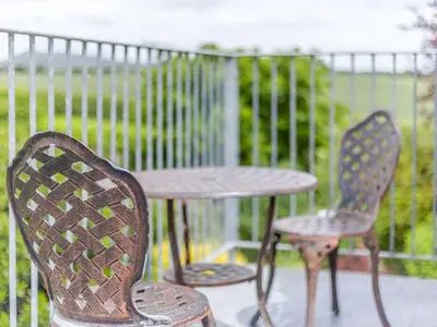 two chairs and a table on a patio at Robin's Nest in Craven Arms