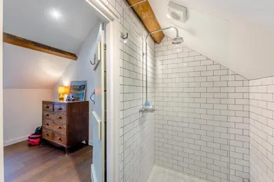 a bathroom with white subway tiles and a walk in shower at 4 Bed in Llangower oc-f31072 in Llangower