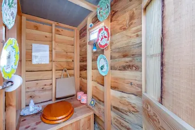 a wooden bathroom with a toilet and a wooden wall at 1 Bed in Ffestiniog oc-c31093 in Ffestiniog