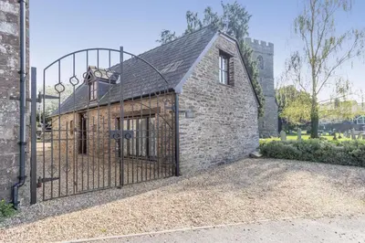 a brick building with a gate in front of it at 2 Bed in Llangorse oc-p31754 in Llangorse