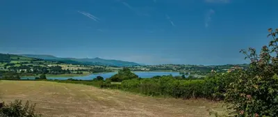 a view of a lake from a hill with a field at 2 Bed in Llangorse oc-p31754 in Llangorse