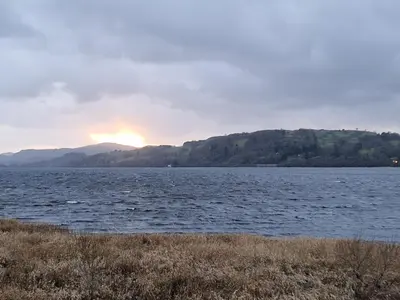 a sunset over a large body of water at Old Ty'n Y Wern in Bala