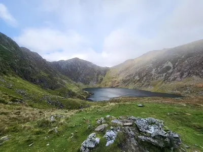 a mountain lake in the middle of a valley at POD4 Family Glamping with seaview & Wi-Fi in Llwyngwril