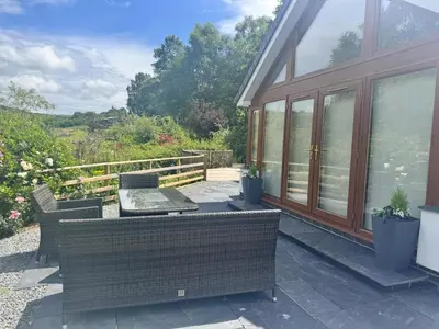 a patio with a table and chairs on a house at 4 Bed in Llanidloes oc-95968 in Van