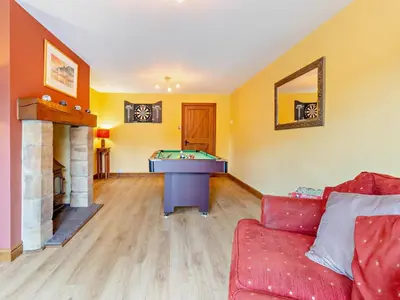 a living room with a couch and a pool table at 4 Bed in Llanidloes oc-95968 in Van
