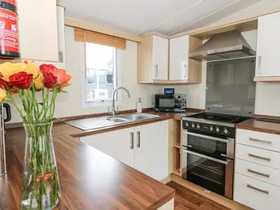 a kitchen with a vase of flowers on a counter at 21 Bay View in New Quay