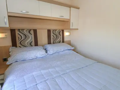 a bedroom with a bed with two pillows on it at 21 Bay View in New Quay