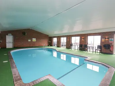 a large pool with blue water in a building at 21 Bay View in New Quay