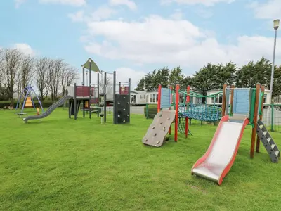 a group of playground equipment in a park at 21 Bay View in New Quay