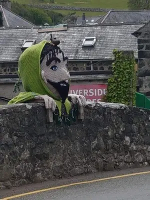 a statue of a bug on a stone wall at POD6 Family Glamping with seaview & Wi-Fi in Llwyngwril