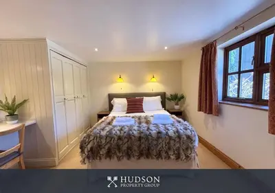 a bedroom with a bed and a desk and a window at Private Cottage in Shrewsbury in Shrewsbury