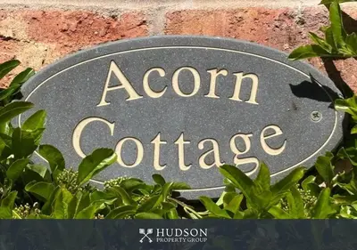 a sign that says acorn coffee next to some plants at Private Cottage in Shrewsbury in Shrewsbury