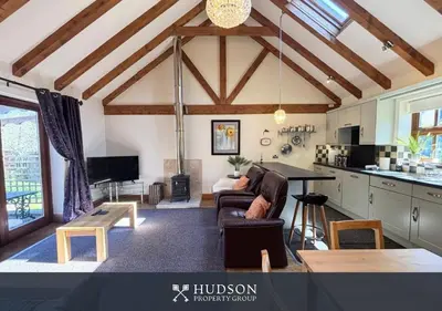 a living room with a couch and a table at Private Cottage in Shrewsbury in Shrewsbury
