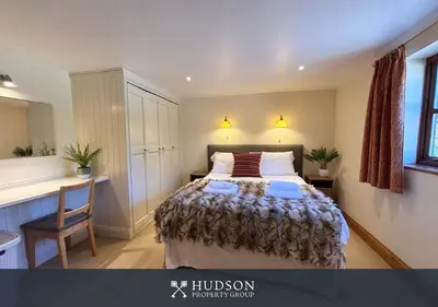 a bedroom with a bed and a desk at Private Cottage in Shrewsbury in Shrewsbury