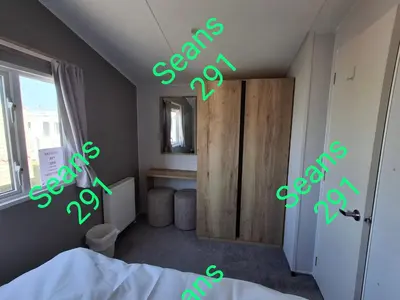 a room with a bed with green letters on the wall at Seans 291 sandy cove 041 in Barmouth