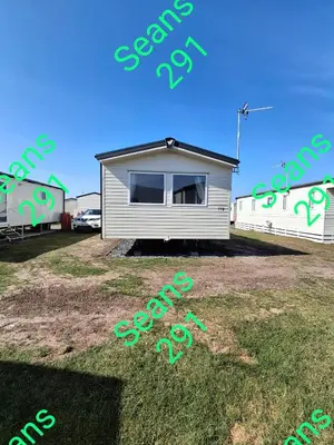 a mobile home is sitting on the grass at Seans 291 sandy cove 041 in Barmouth