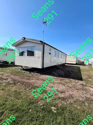 a trailer sitting on top of a grass field at Seans 291 sandy cove 041 in Barmouth