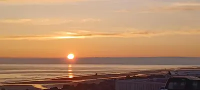 a sunset on the beach with the sun setting at Beehive 136 snowdon summit 100 in Barmouth