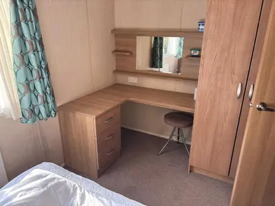 a desk with a mirror and a chair in a room at The Lookout 3 Bedroom Family Caravan Pet Friendly in Aberystwyth