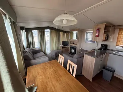 a kitchen and living room with a table and a caravan at The Lookout 3 Bedroom Family Caravan Pet Friendly in Aberystwyth