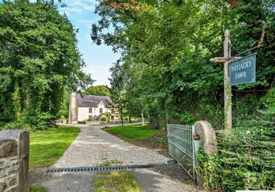 a street sign with a house in the background at Beautiful Brecon Beacon House in Llandovery