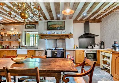 a large kitchen with a wooden table and chairs at Beautiful Brecon Beacon House in Llandovery