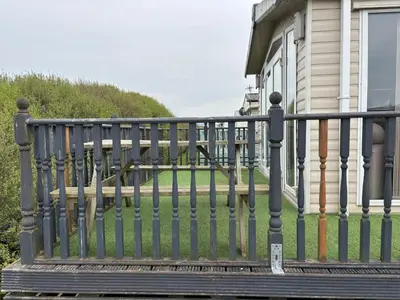 a black fence in front of a house at The Beach Hideaway Pet Friendly 2 Bedroom Static Caravan Clarach Bay in Aberystwyth