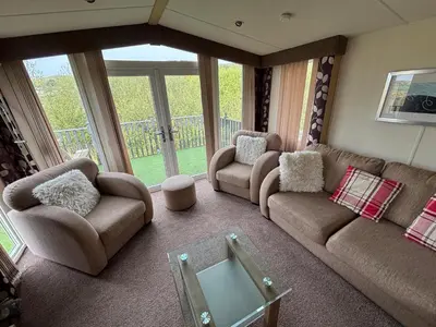 a living room with two couches and a table at The Beach Hideaway Pet Friendly 2 Bedroom Static Caravan Clarach Bay in Aberystwyth