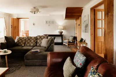 a living room with a couch and a table at Cambrian Farm House by Birch Stays in Devils Bridge