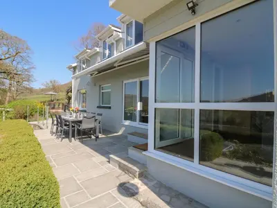 a house with large windows and a patio at Curtau in Builth Wells