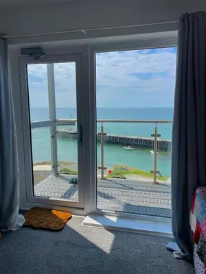 a room with a window with a view of the ocean at Duplex apartment with spectacular sea views! in Aberystwyth
