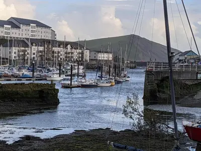 a bunch of boats are docked in a harbor at Duplex apartment with spectacular sea views! in Aberystwyth