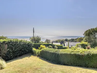 a garden with bushes and hedges at Verbier Luxurious Seaside Retreat in Aberdyfi