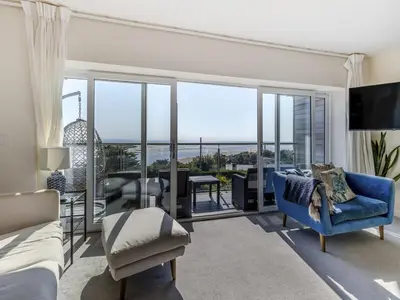 a bedroom with a bed and a living room at Verbier Luxurious Seaside Retreat in Aberdyfi