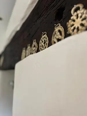 a bunch of gold buttons on a wooden drawer at Peaceful Dyfi Valley Cottage - Hendre-gau in Machynlleth