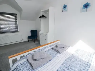 a bedroom with a bed with two pillows on it at The Coach House in Dolgellau