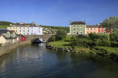 a bridge over a river in a town with buildings at Geraig Aberaeron in Aberaeron