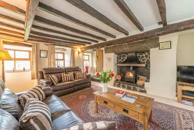 a living room with a couch and a fireplace at Ty-Mawr in Llanuwchllyn