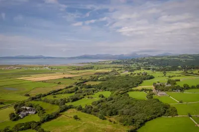 an aerial view of a field with trees and water at Gegin-Faeldre in Llanbedr
