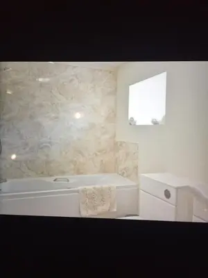 a bathroom with a white tub and a sink at Coastal Bliss Charming Cottage near Borth beach in Borth