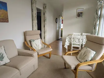 a living room with a couch and chairs and a table at Delightful Chalet Peaceful Site Near Aberdyfi in Tywyn
